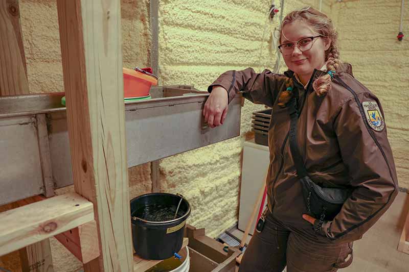 Rebekah Ewing stands with mussels at the U.S. Fish and Wildlife Service Erwin National Wildlife Refuge.