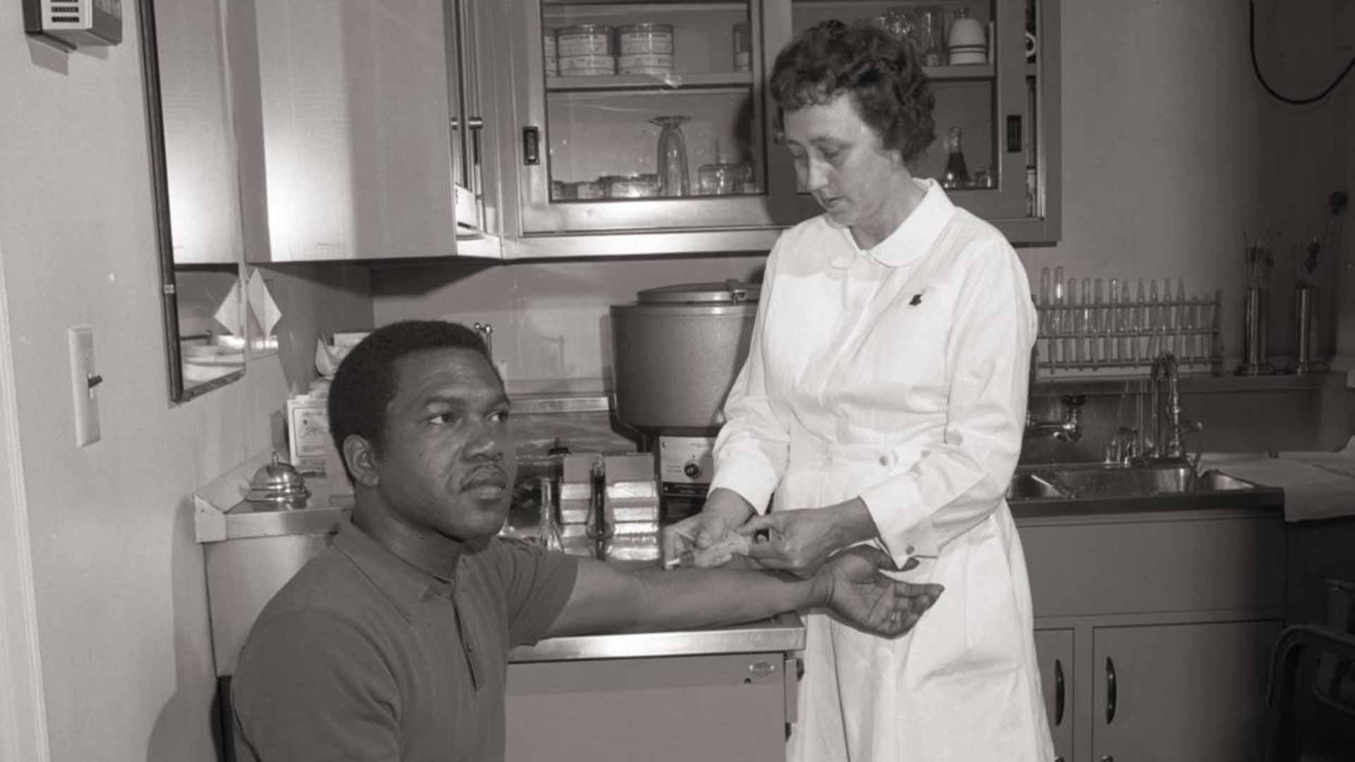 A man receiving a shot in the arm.