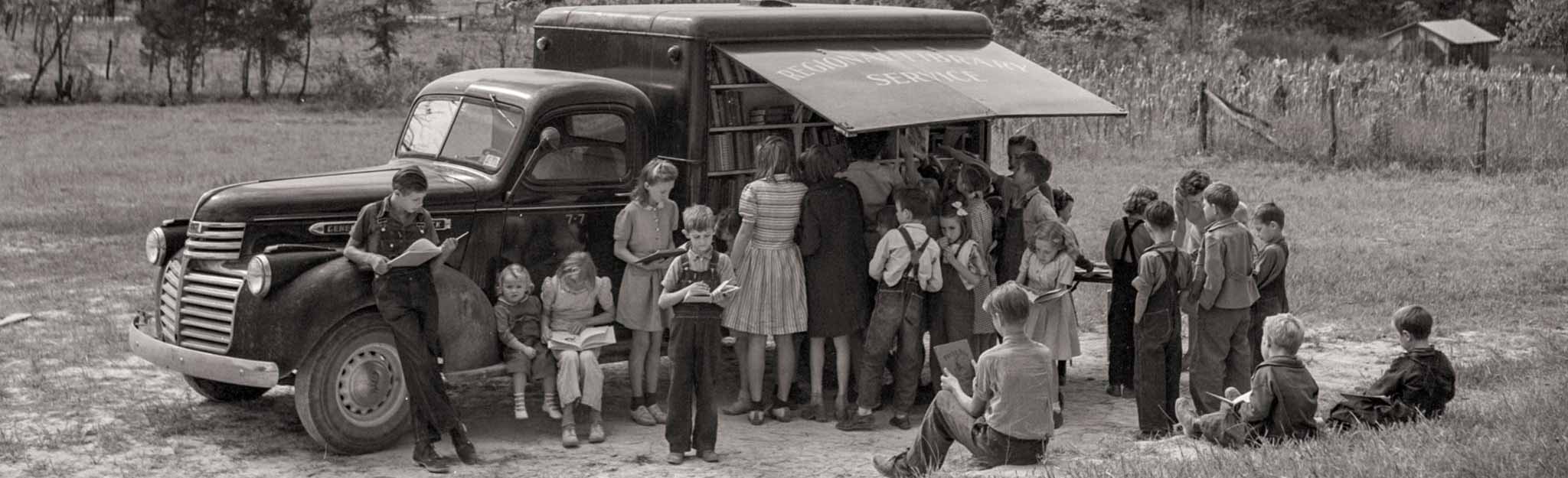 A group of citizens outside the truck library.
