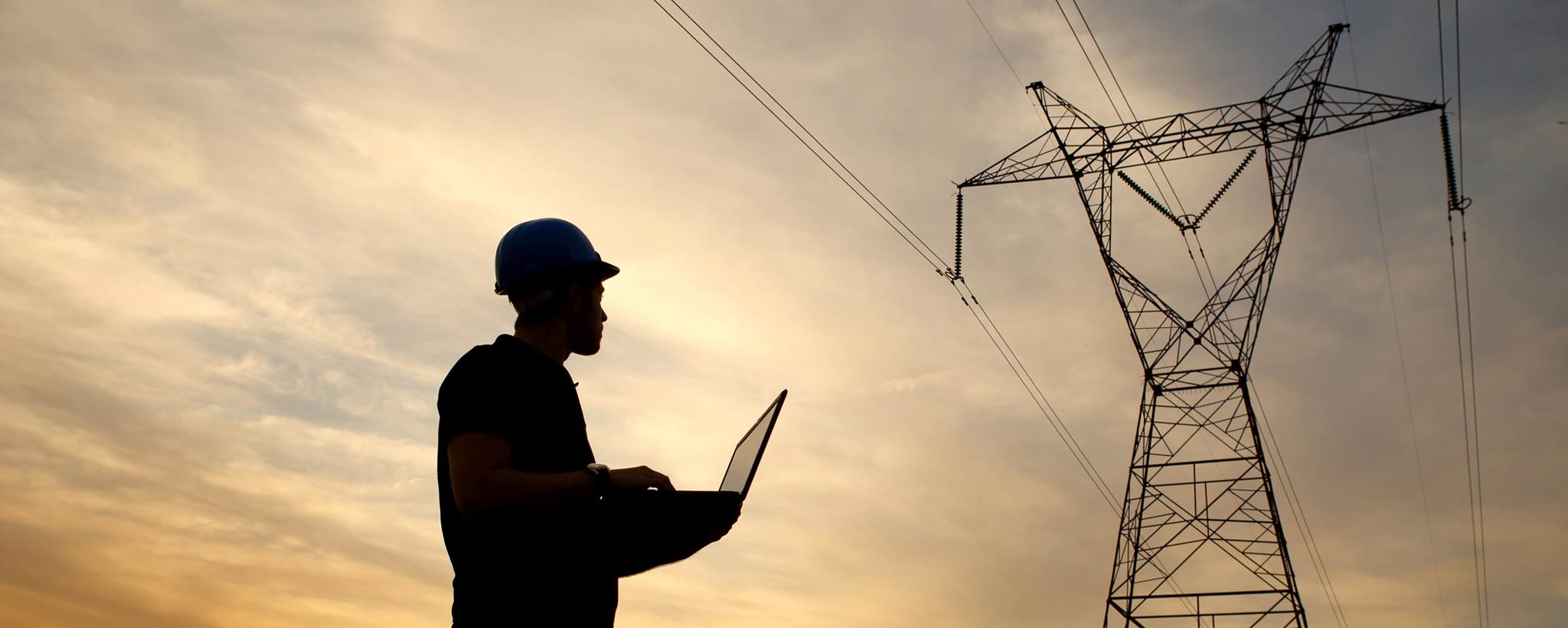 Engineer working near high-voltage tower Engineer Working near a High-Voltage transmission tower