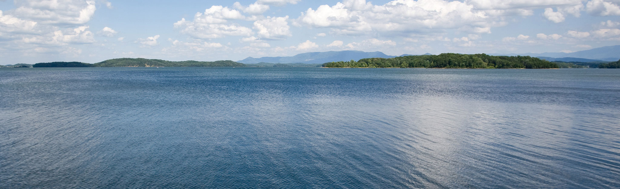 TVA reservoir under a blue sky with clouds