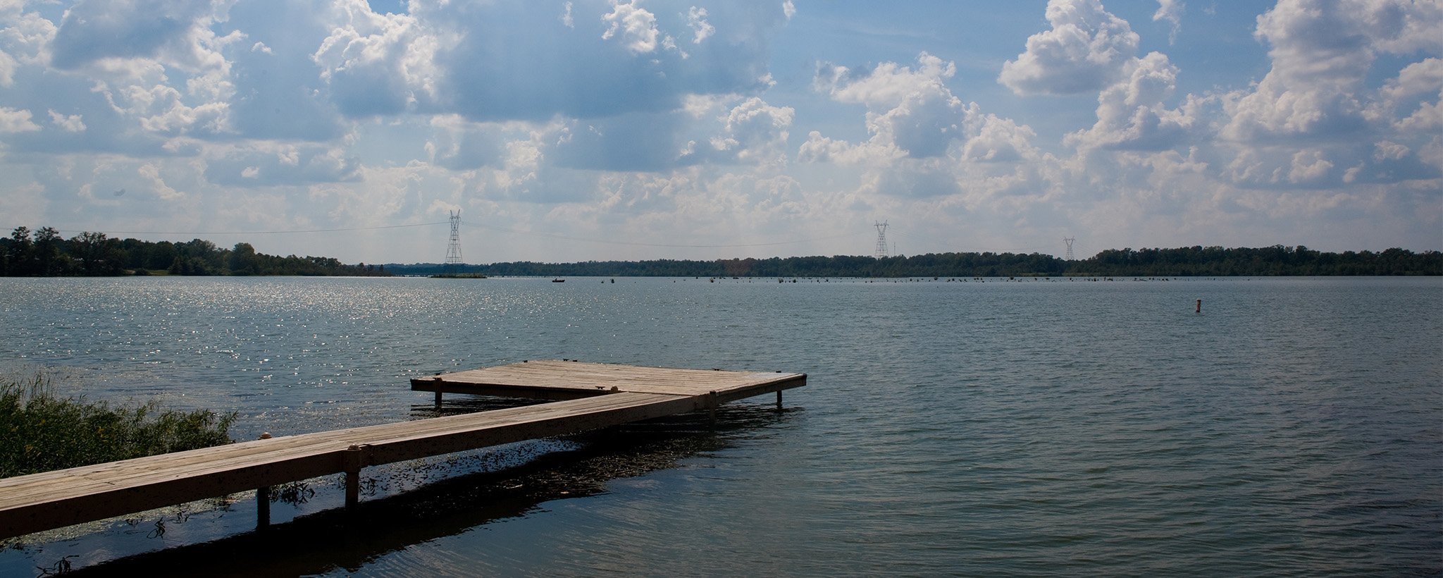 Dock under puffy clouds