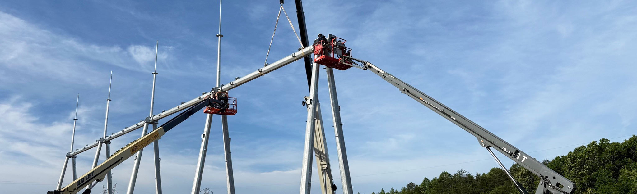 Electrician apprentices working from bucket trucks.