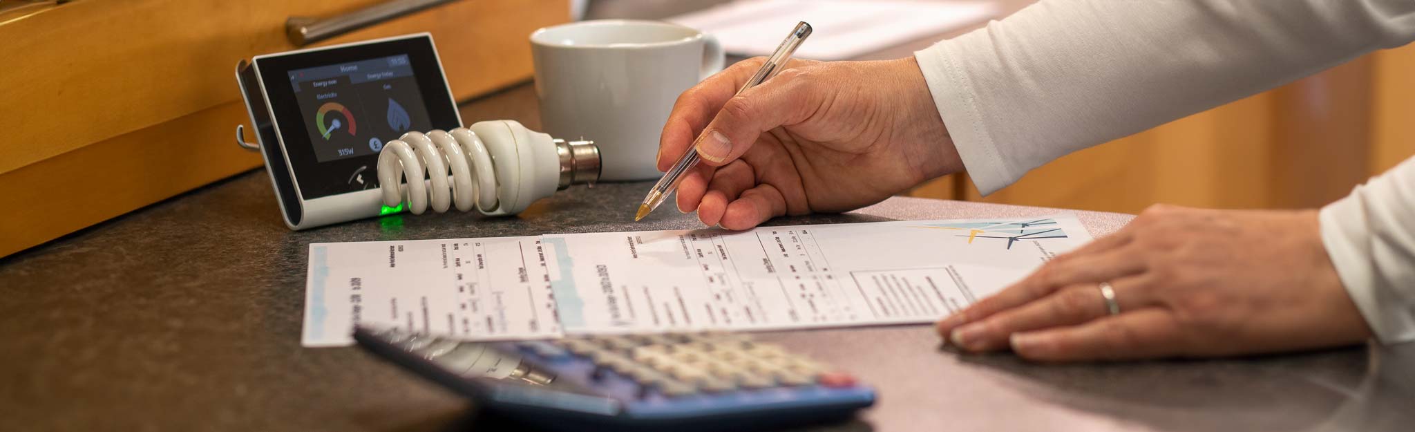Close-up of energy bills and Smart Meter on a kitchen worktop