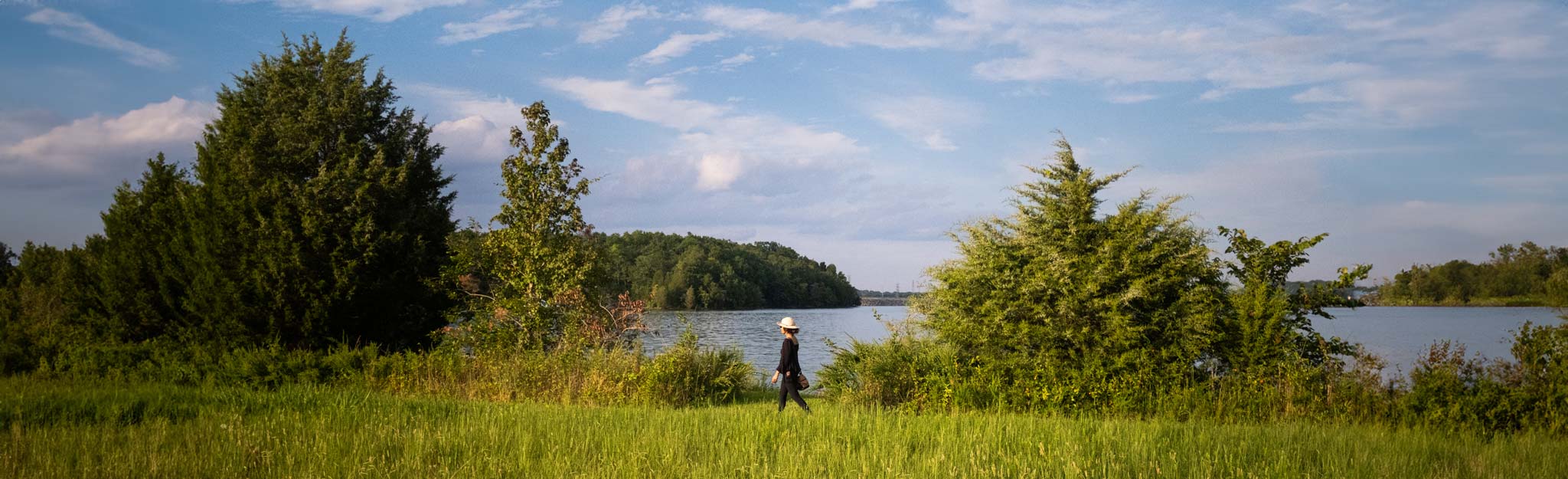 woman walking beside lake