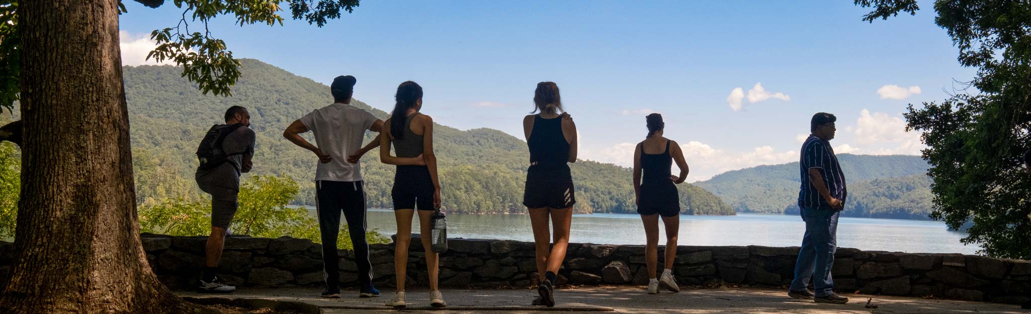 people looking out over a lake