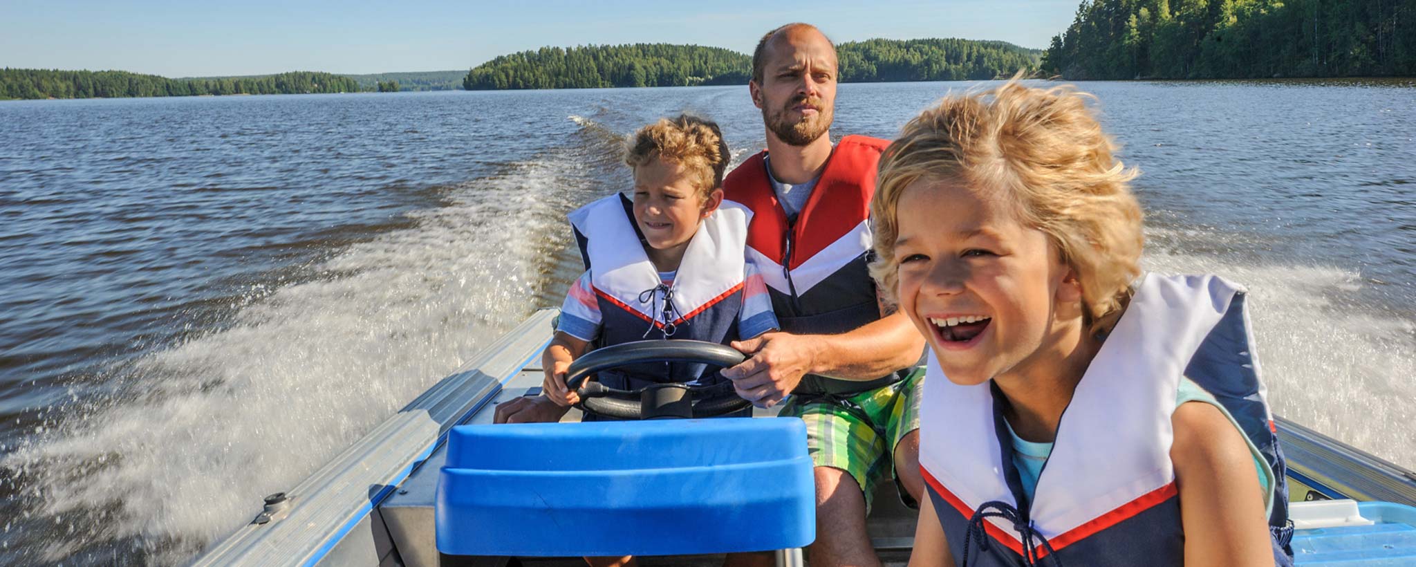 Father and kids boating on lake