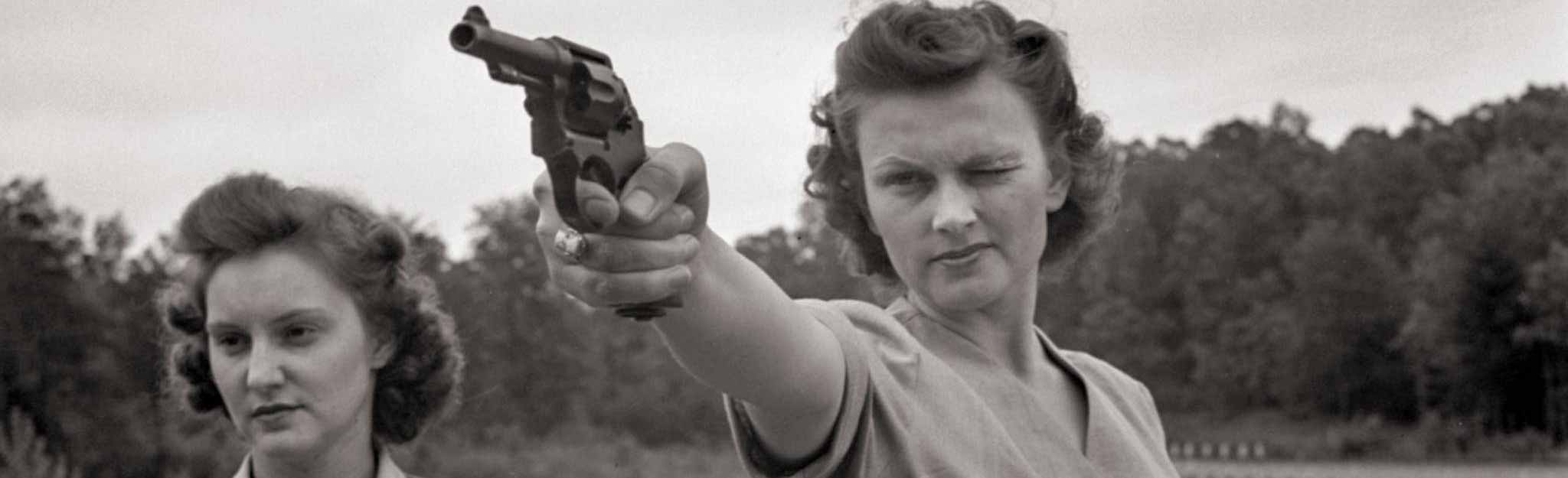 Woman aiming pistol