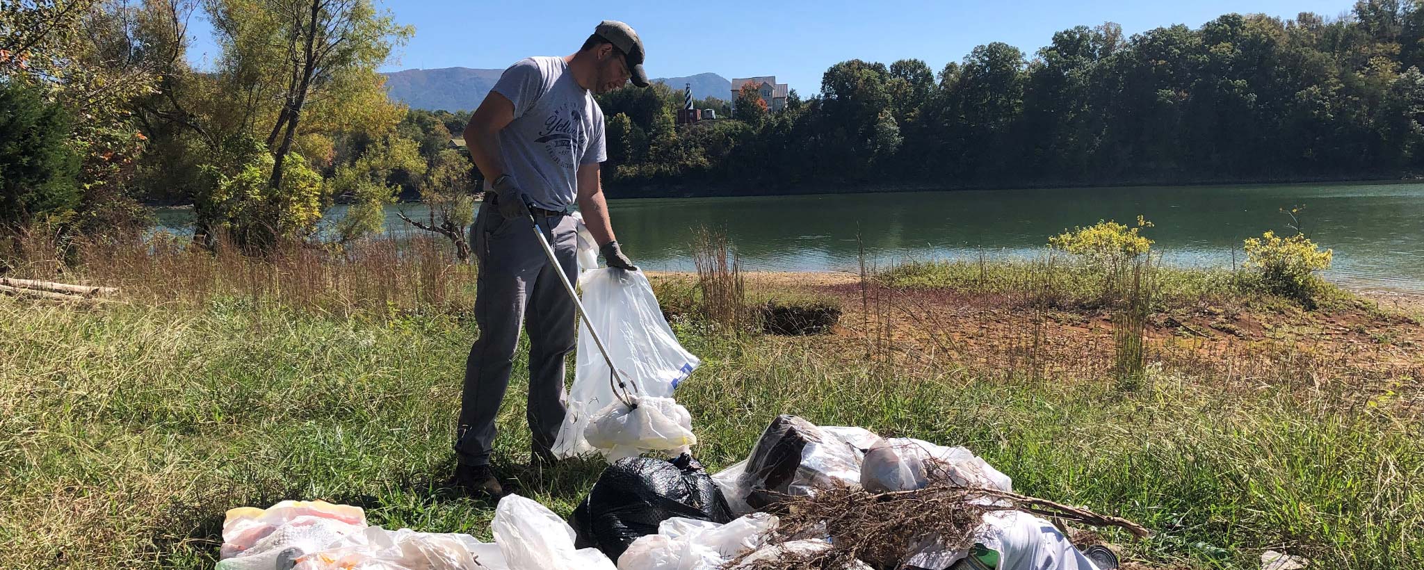 Man picking up the trash in a camp ground Man picking up the trash in a camp ground