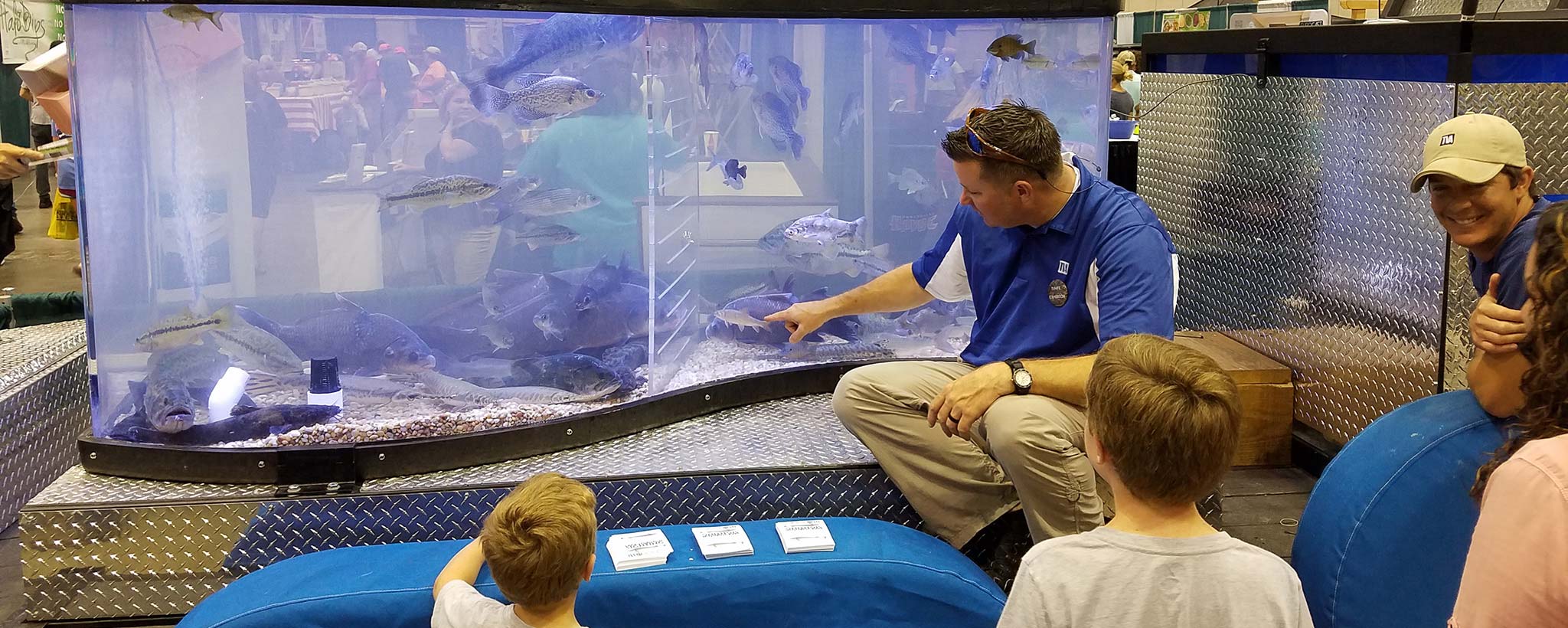 TVA biologist showing the mobile aquarium at an event