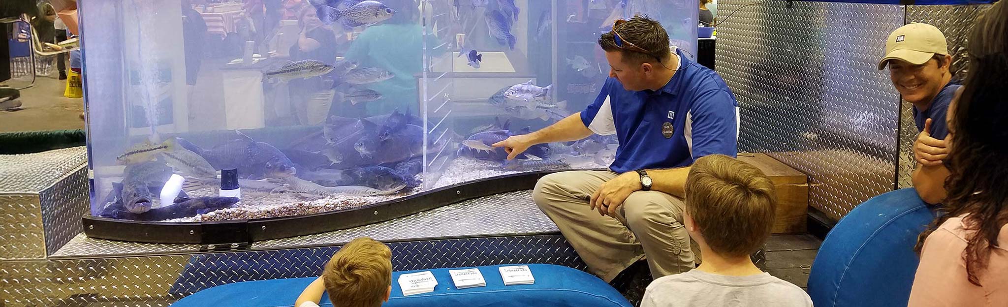 TVA biologist showing the mobile aquarium at an event