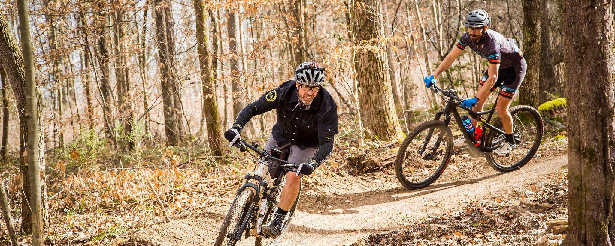 Two mountain bikers ride along a trail at the Loyston Point Trail system near Norris Lake