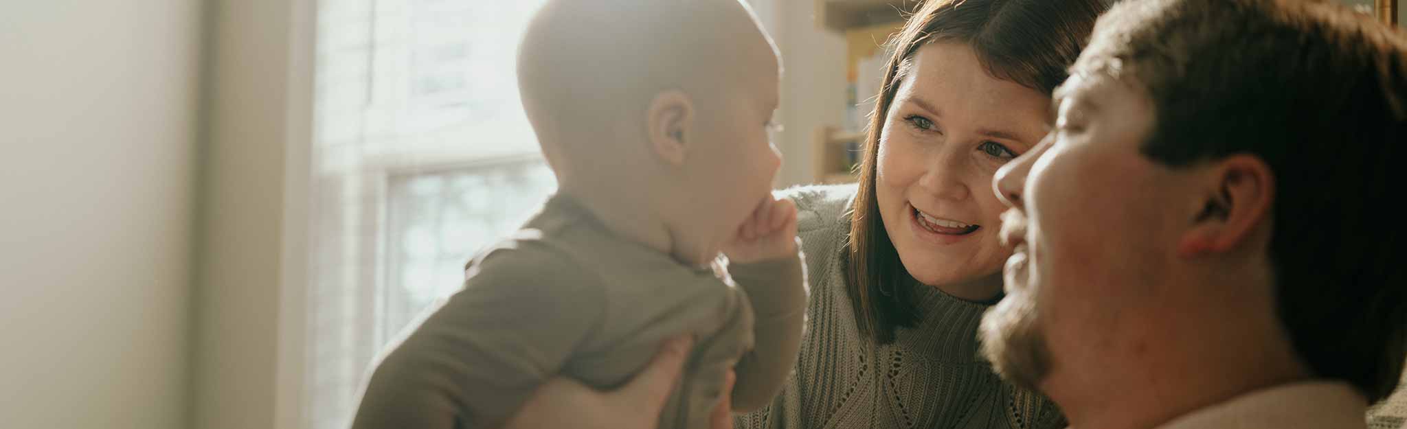 Parents smiling at baby