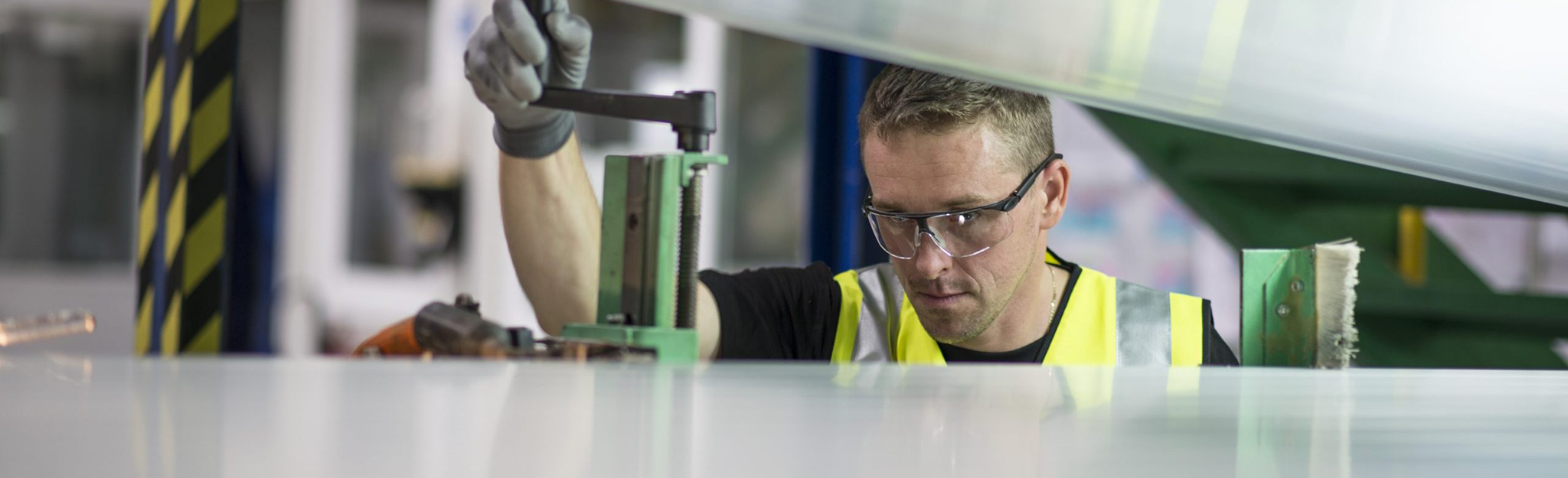 Worker in manufacturing facility.