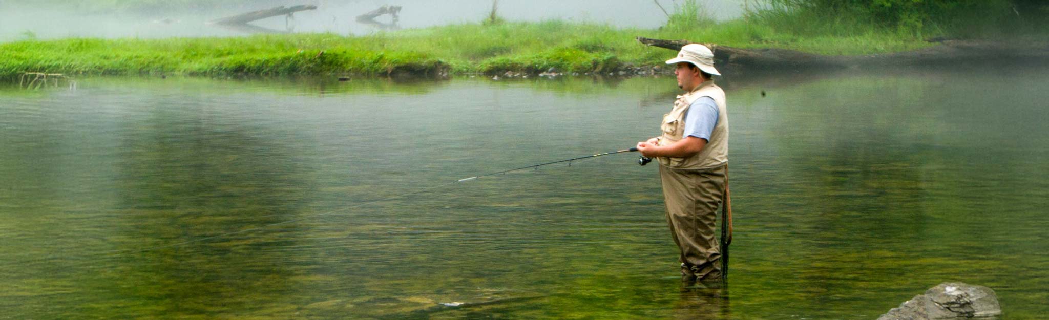 A person fishing in the South Holston River