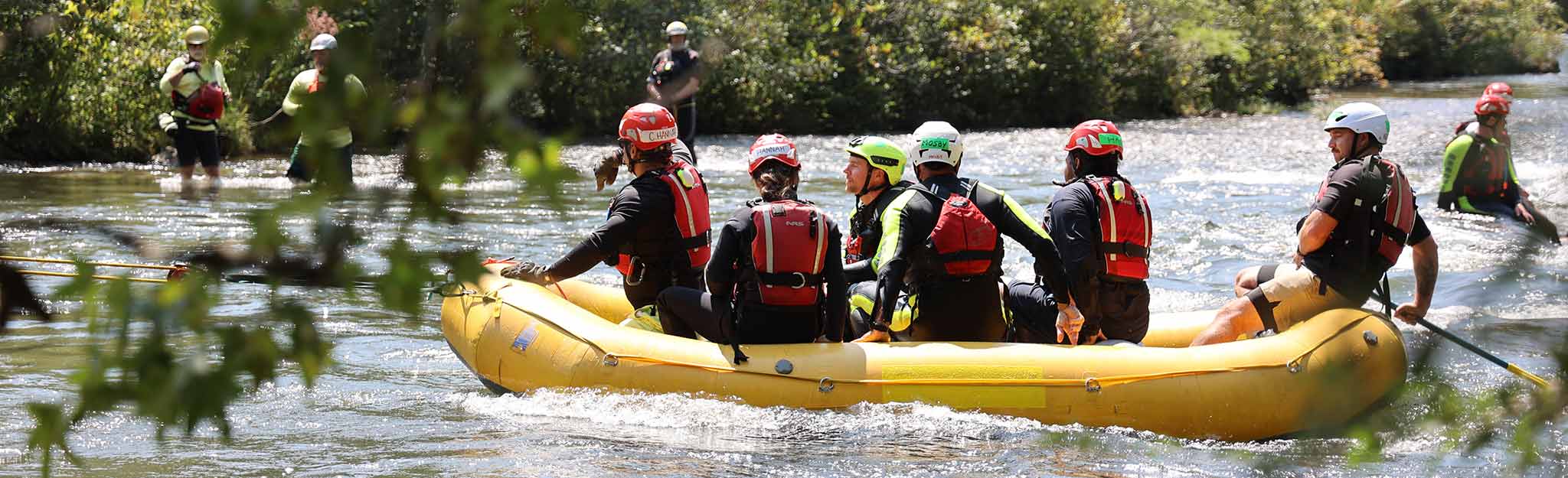 Swift-water rescue training participants in raft on Ocoee River