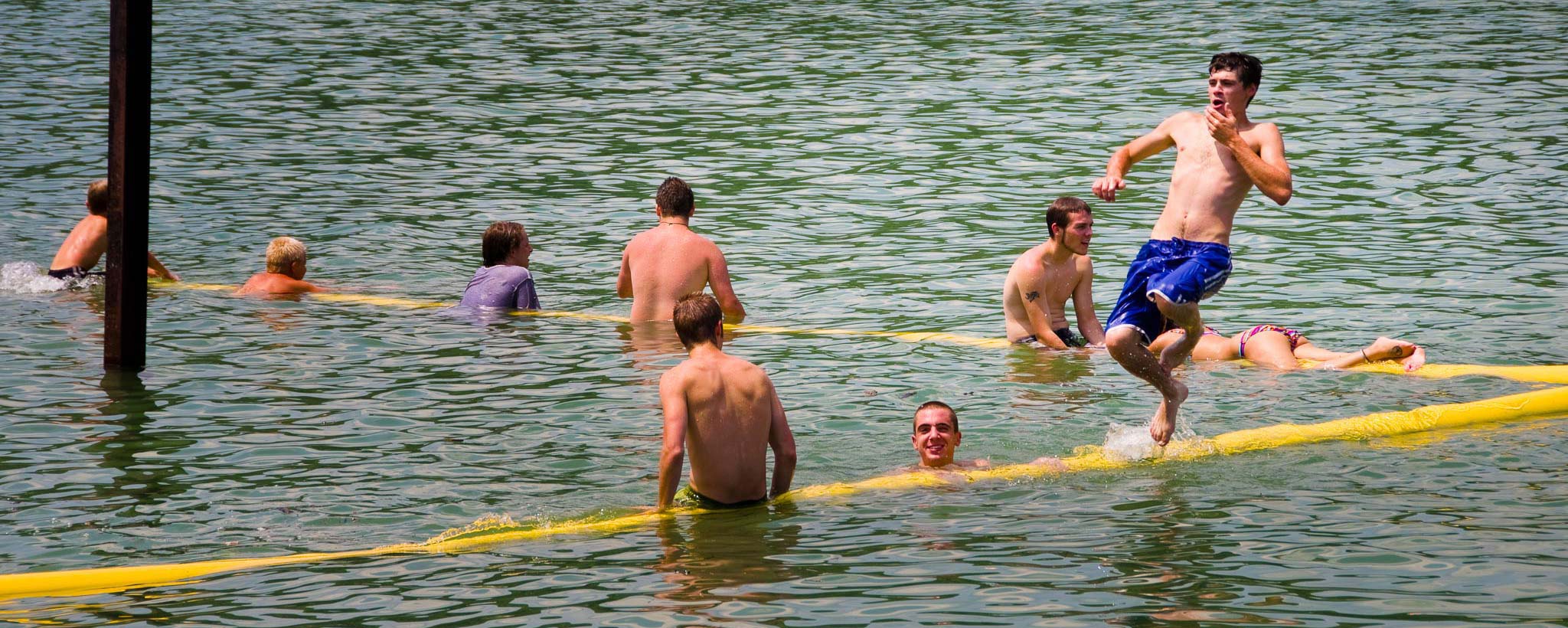 bunch of people swimming in a beach