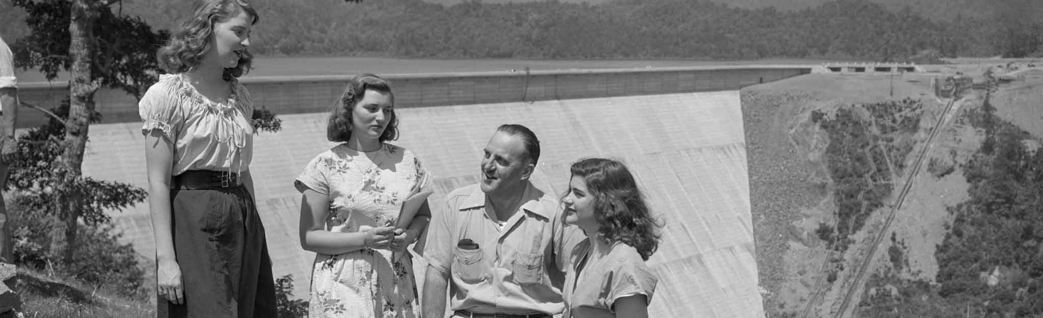 People standing at overlook with Fontana Dam in the background