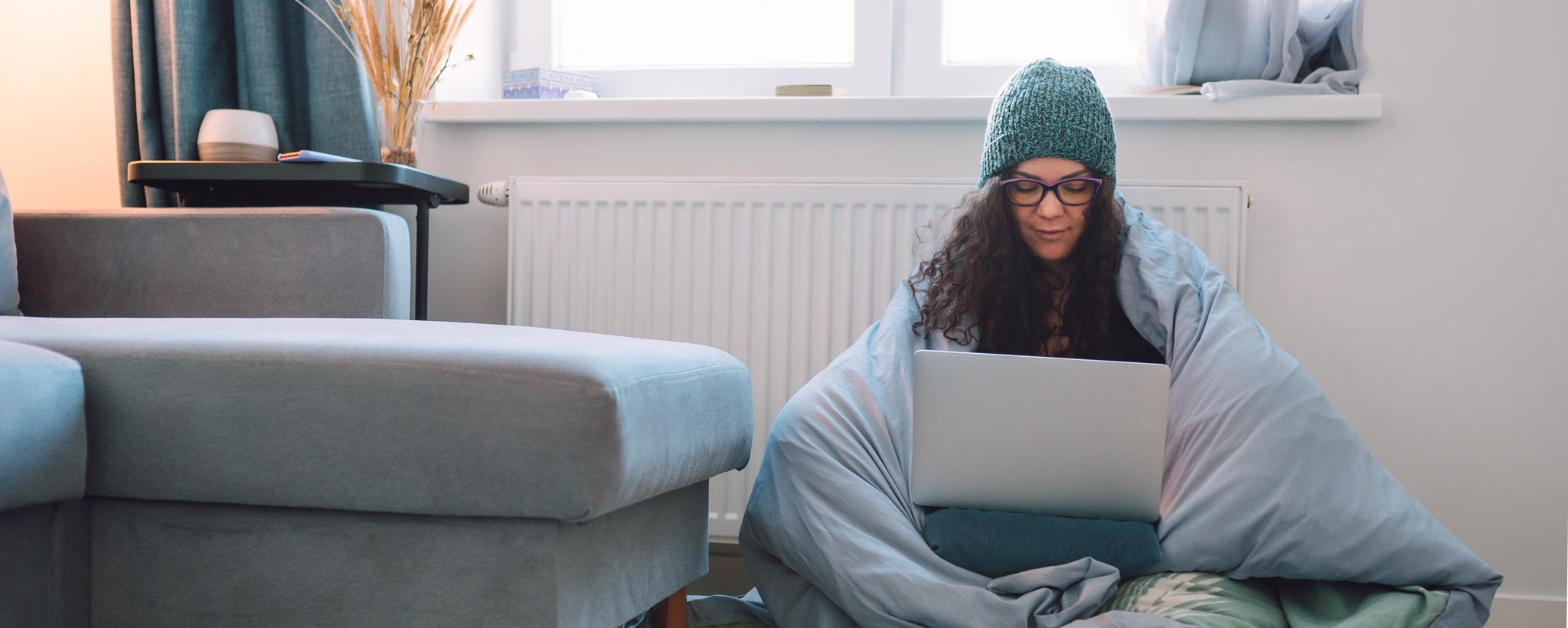 Stay warm hero Woman on laptop staying warm
