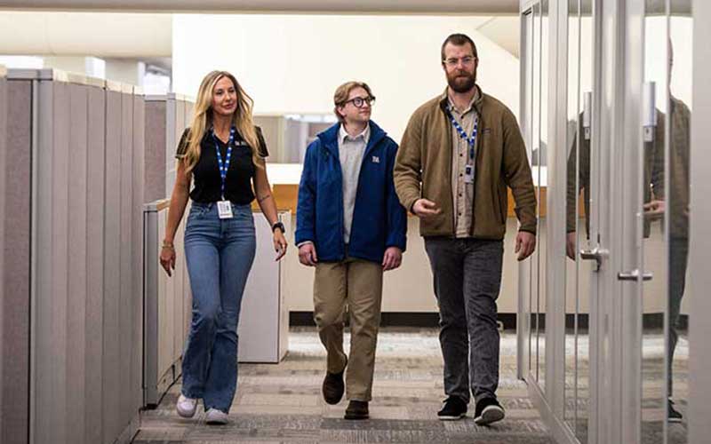 Data analysts walk through hallway at TVA offices