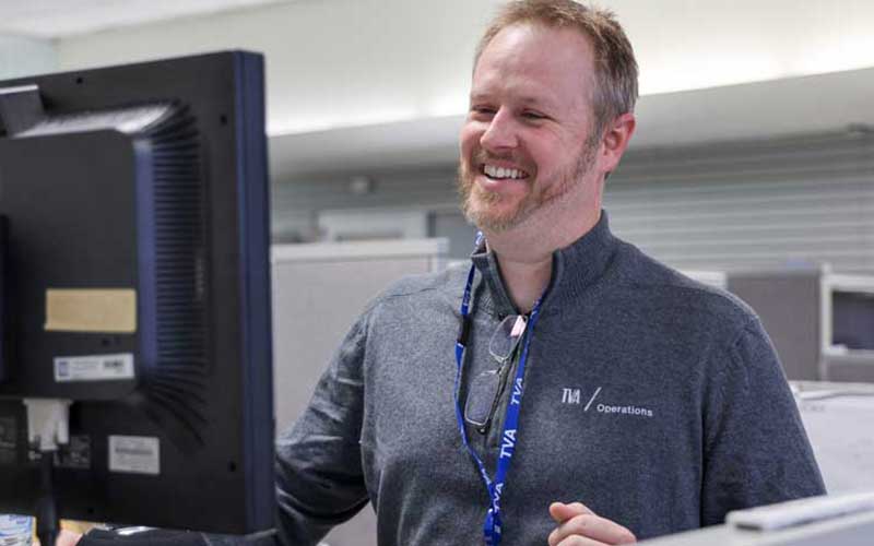 Electrical engineer Timothy Fritch at a computer