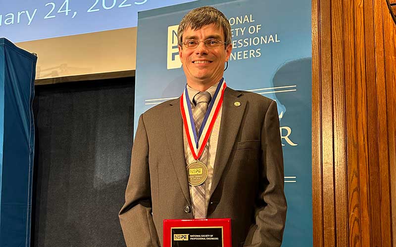 Electrical Engineer Stephen Craven with award