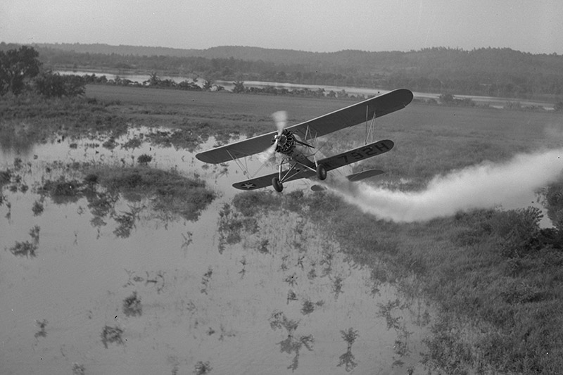 A malaria control plane sprays near Wheeler Lake in Alabama, August 1943.