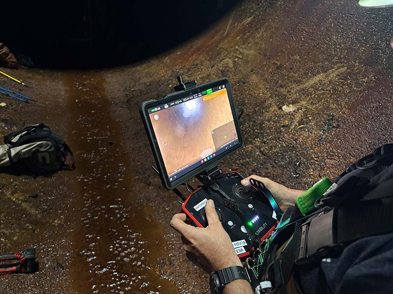 A video feed of the drone’s view as a crew member pilots it through the penstock.