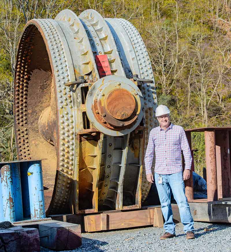 Bell stands next to the old butterfly valve.