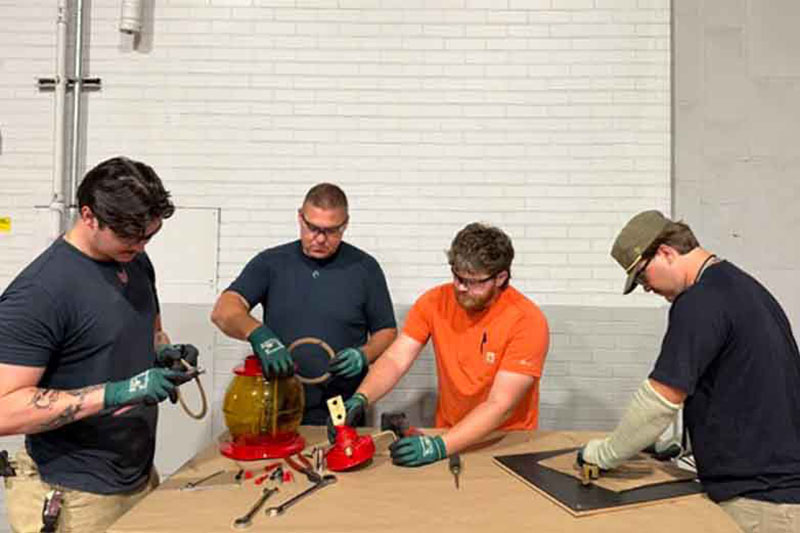 Group of TVA electricians refurbish a 1920s-era bushing for the Belfast Switchyard near Columbia, Tnnessee.