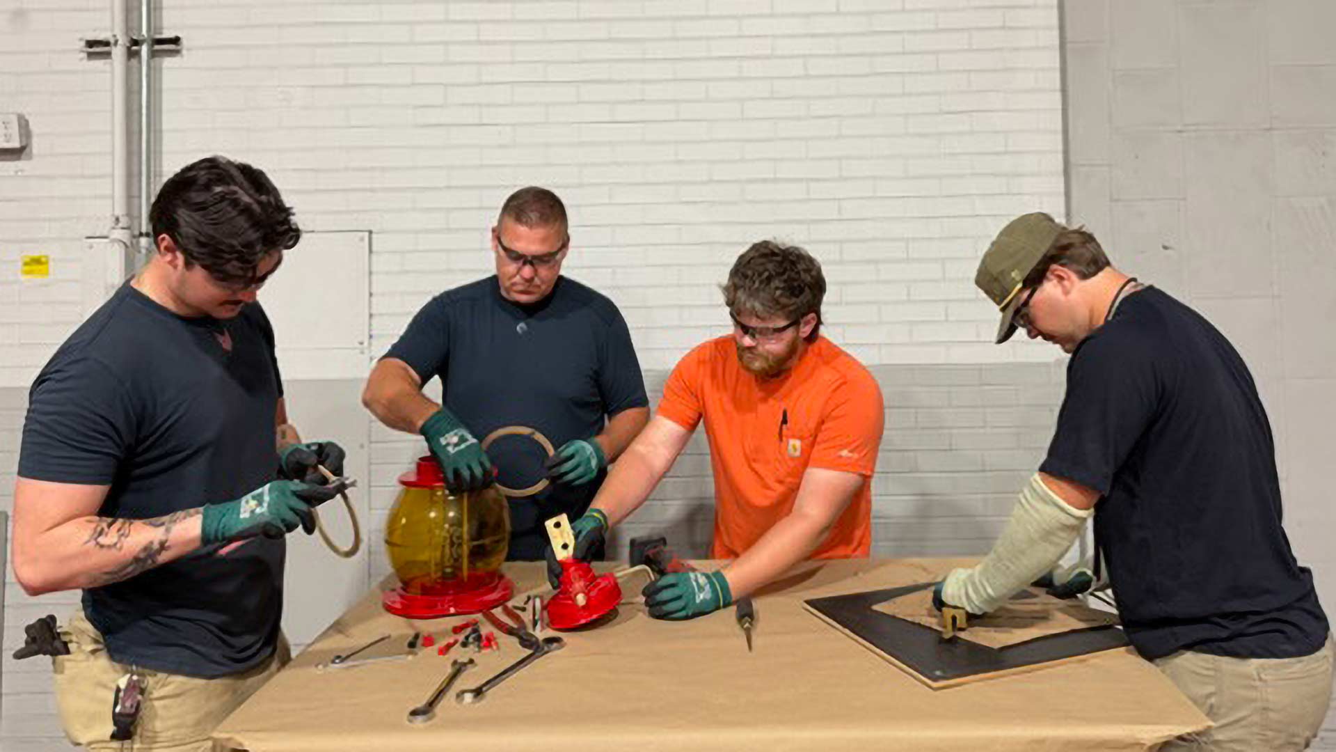 Group of electricians work to refurbish a 1920s-era General Electric bushing
