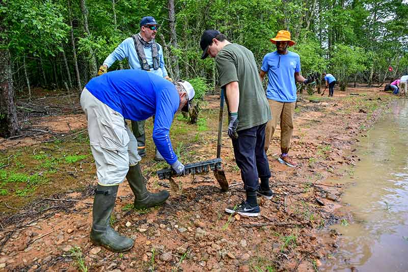 TVA fisheries biologists Kurt Lakin and John Justice with TVA volunteers Frank Salinas and Guerin Higgins at Chatuge Reservoir.