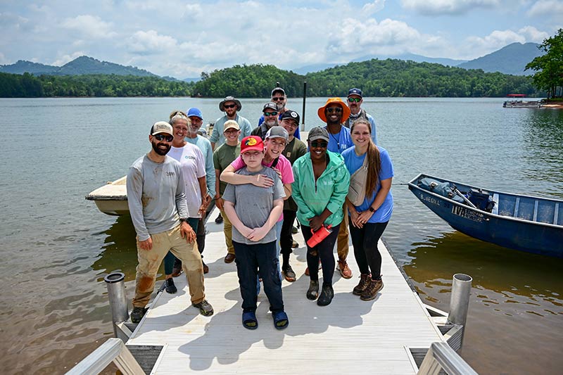 TVA staff and volunteers joined members of the public and Georgia Department of Natural Resources to plant shore-stabilizing water willow and buttonbush at Chatuge Reservoir.