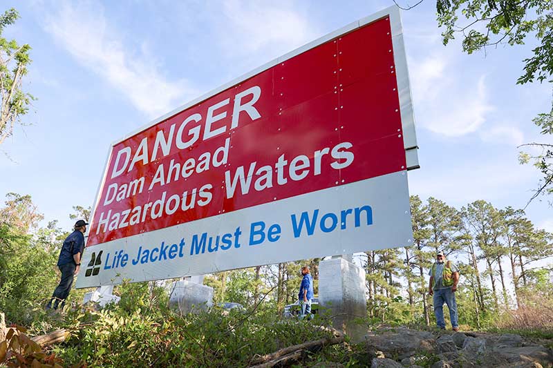 Sign downstream of the dam warns of hazardous waters