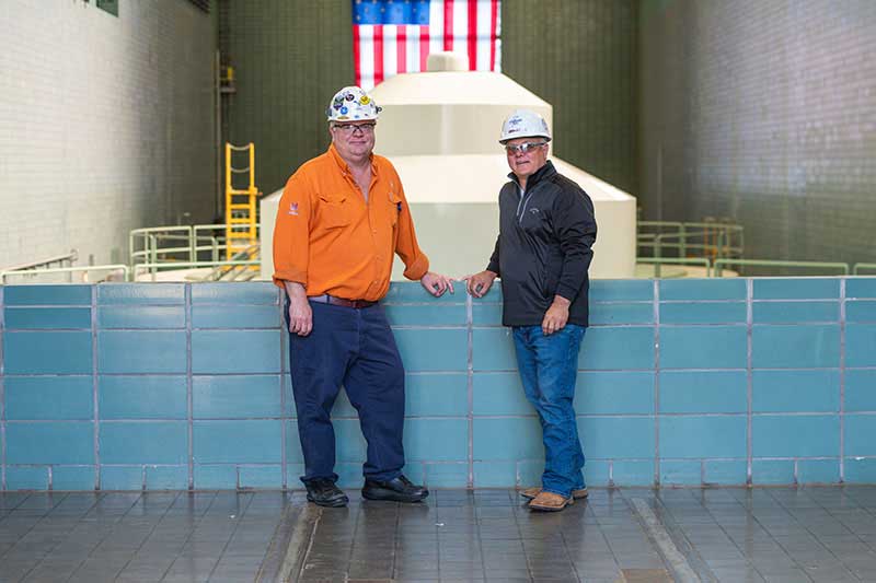 Slade Miller, Hydro Technician IV, and Adams near a Guntersville generating unit.