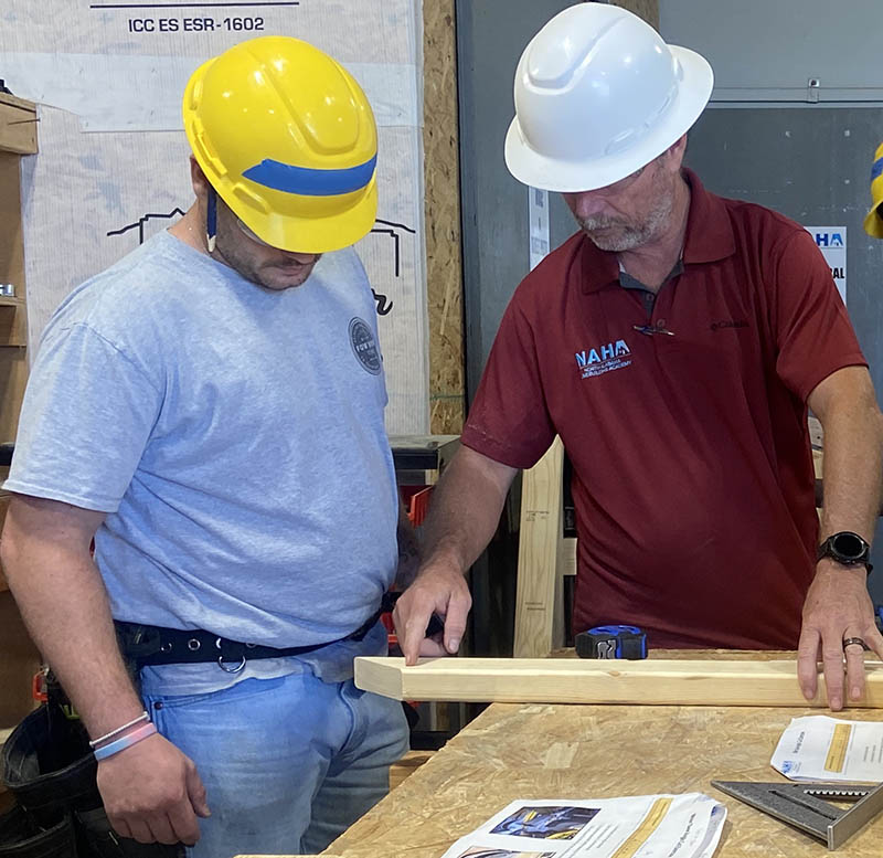 Instructor shares information on how to mark and cut a board at the North Alabama Homebuilding Academy.