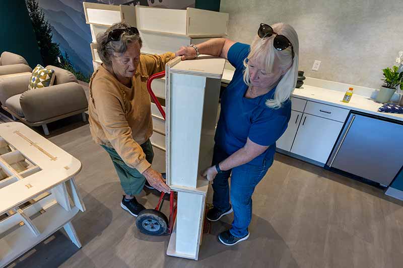 Volunteers unloading furniture in a new home.