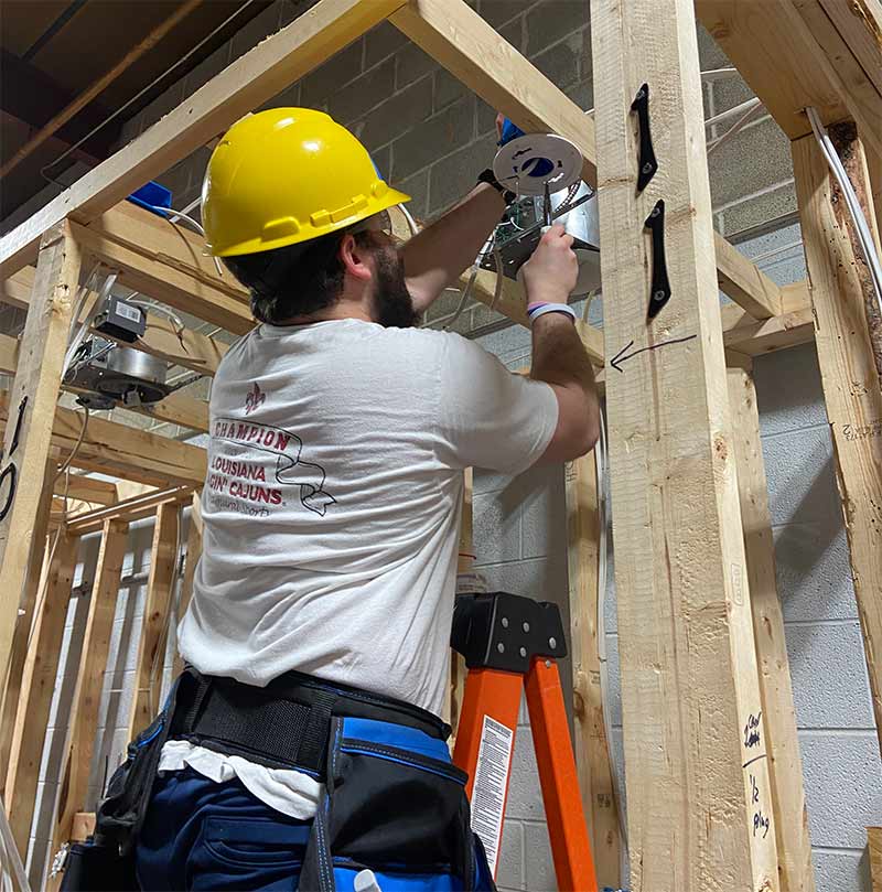A student in the NAHA program operates equipment.