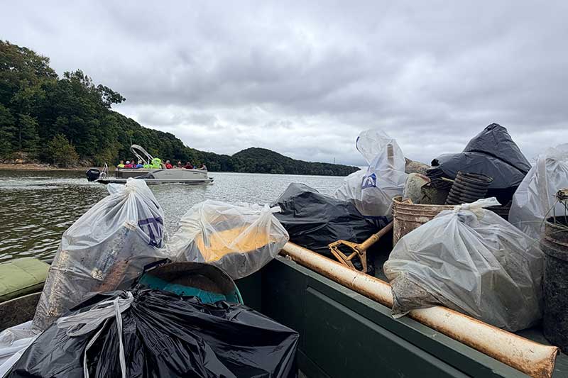 Volunteers cleaned up the shoreline along Trace Creek, removing debris left by the 2021 Humphreys County Flood.