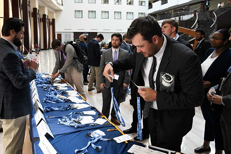 Students attending the conference pick up name tags