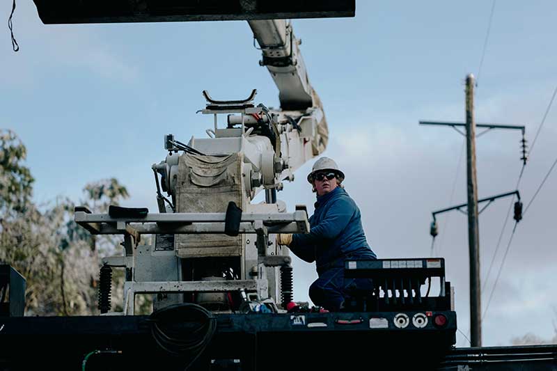 Lineworker operates lift on truck