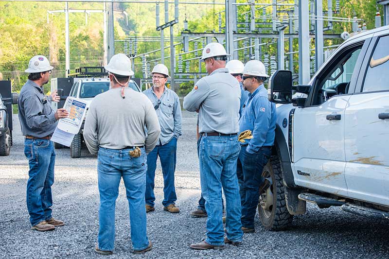 Lineworkers gather for a morning safety brief