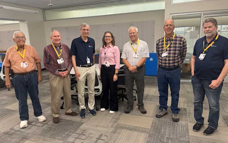 Phil Brown visits with colleagues he worked alongside over decades