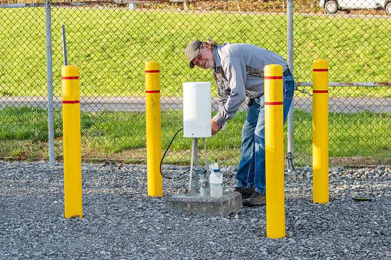 Nunley inspects a rain gauge at Nickajack Reservoir