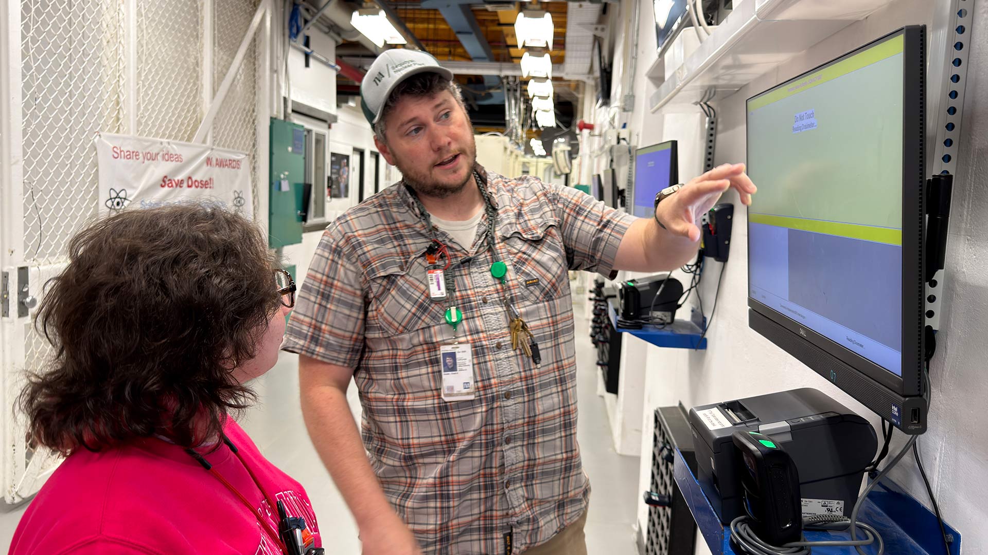 Chad Dozier shows a screen to a colleage.