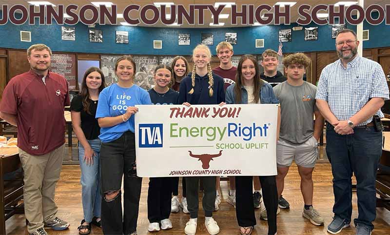 School leaders and students hold a Thank You EnergyRight sign