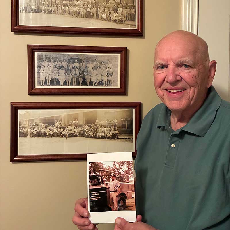 Current photo of Jim Standifer holding a photo of his father, Ranzie Standifer.