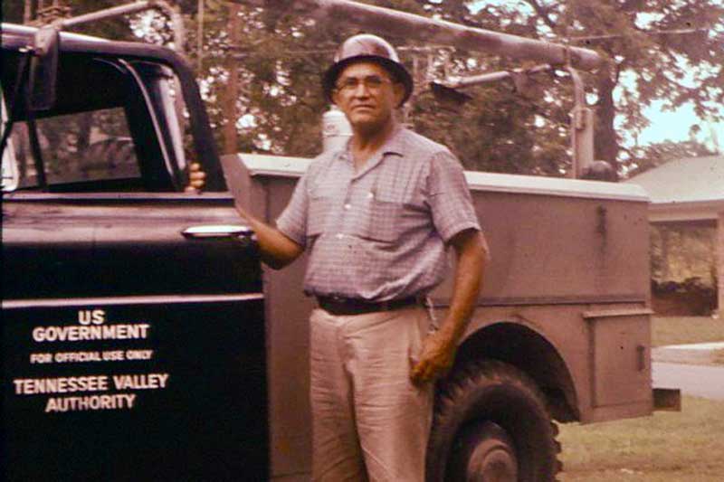 Ranzie Standifer standing with a TVA truck in 1961