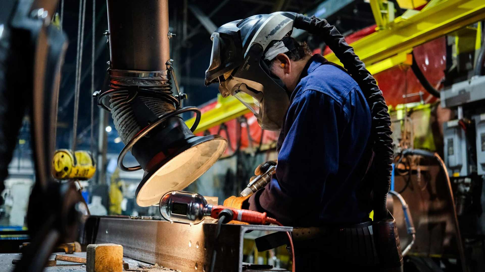 Worker using equipment in an industrial facility.