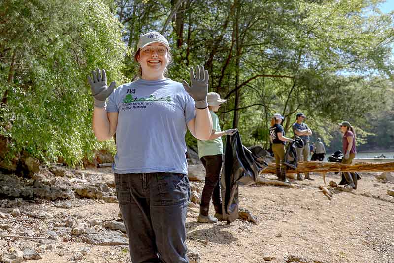 Volunteer at trash pickup wearing gloves